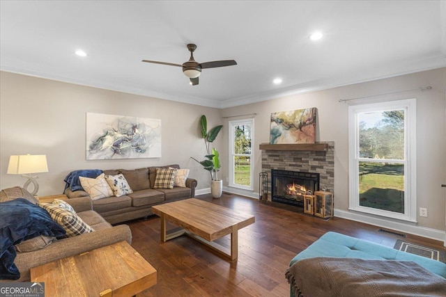 living area featuring ornamental molding, a healthy amount of sunlight, and hardwood / wood-style flooring