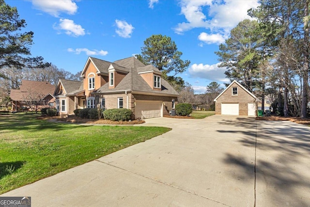 view of front of property featuring a garage, a front yard, concrete driveway, and brick siding