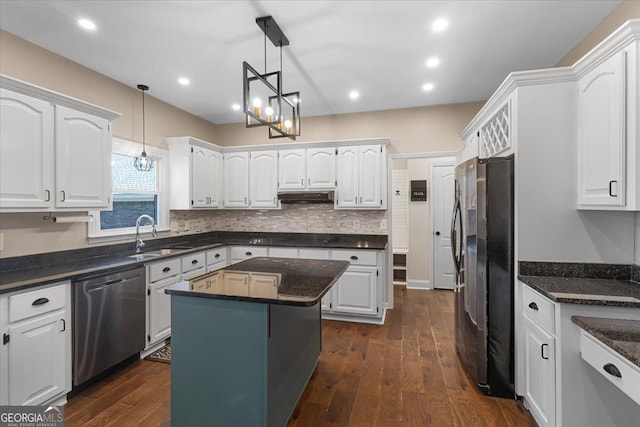 kitchen featuring stainless steel appliances, a sink, white cabinets, and under cabinet range hood