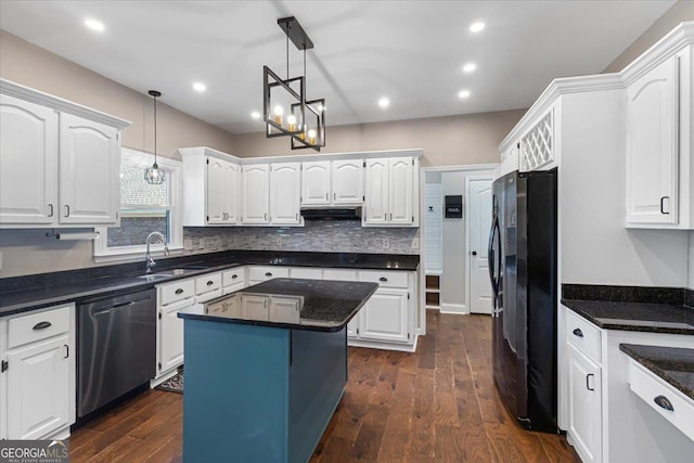 kitchen featuring under cabinet range hood, a sink, white cabinets, freestanding refrigerator, and dishwasher