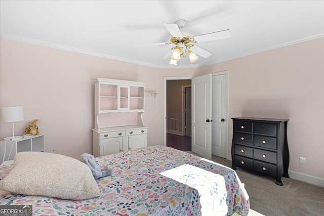 bedroom featuring crown molding, a closet, baseboards, and light colored carpet