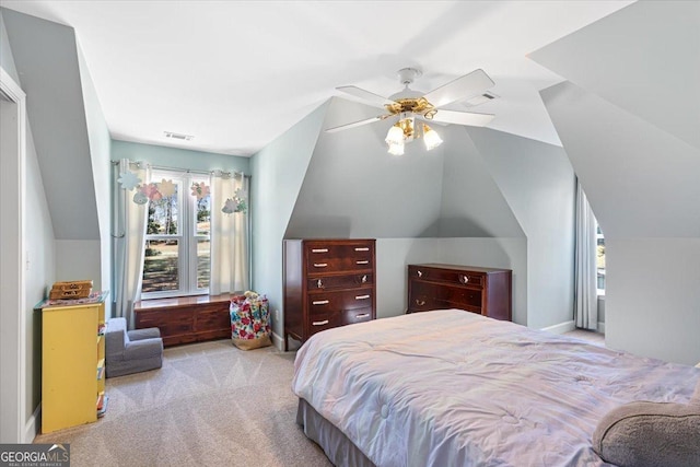 bedroom with a ceiling fan, visible vents, vaulted ceiling, and carpet flooring