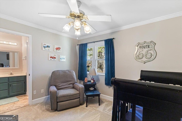 sitting room featuring light carpet, baseboards, and crown molding