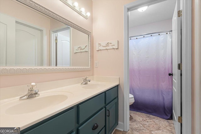 bathroom with double vanity, a shower with shower curtain, a sink, and toilet