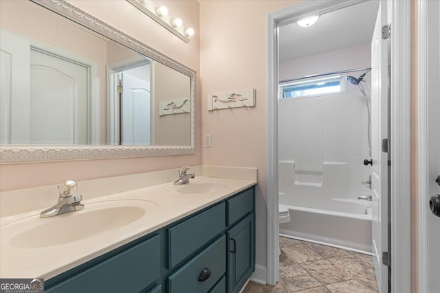 full bathroom with double vanity, toilet, a sink, and shower / bathtub combination