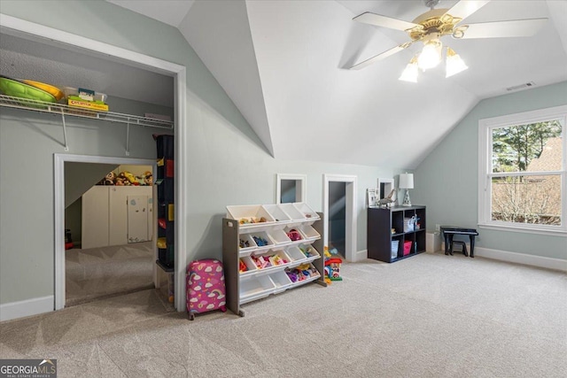 playroom featuring visible vents, baseboards, lofted ceiling, ceiling fan, and carpet