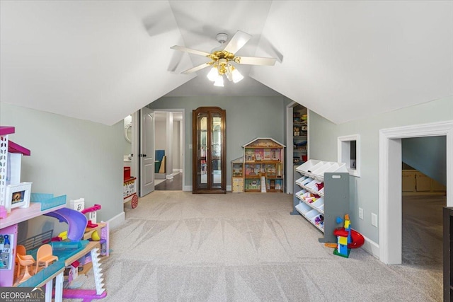 rec room featuring carpet flooring, vaulted ceiling, baseboards, and ceiling fan