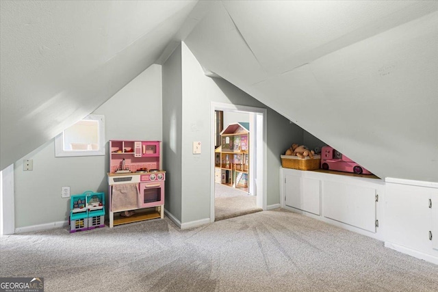 additional living space featuring vaulted ceiling, carpet floors, and baseboards