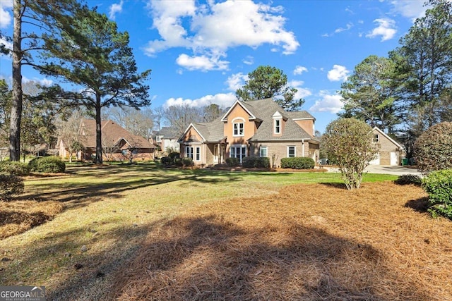 view of front of home featuring a garage and a front lawn