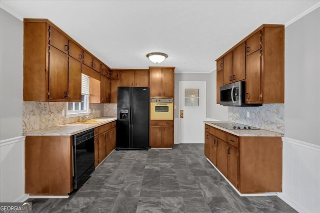 kitchen featuring black appliances, brown cabinets, and light countertops