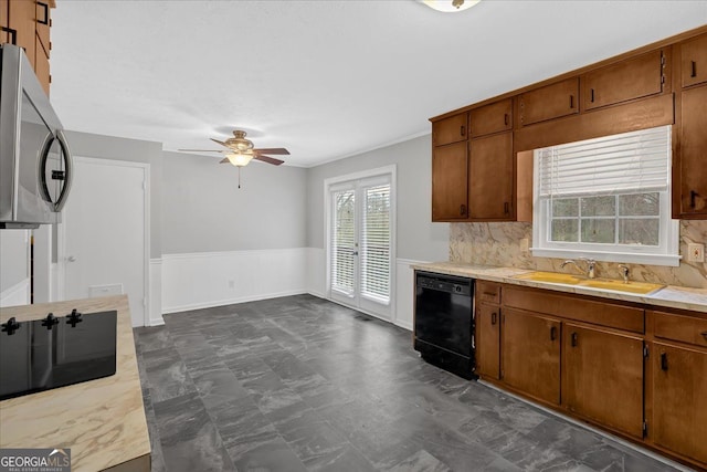 kitchen with a sink, black dishwasher, light countertops, brown cabinets, and stainless steel microwave