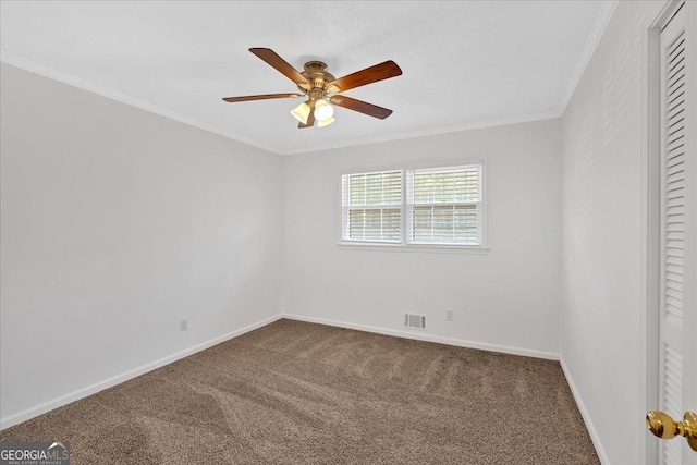 empty room with baseboards, visible vents, carpet flooring, and ornamental molding