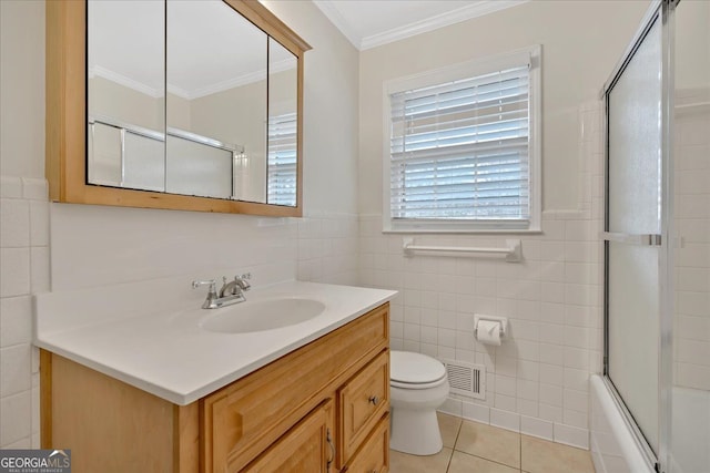 full bathroom featuring tile walls, visible vents, toilet, ornamental molding, and tile patterned flooring