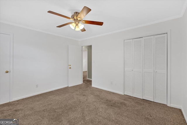 unfurnished bedroom featuring a closet, baseboards, crown molding, and carpet flooring