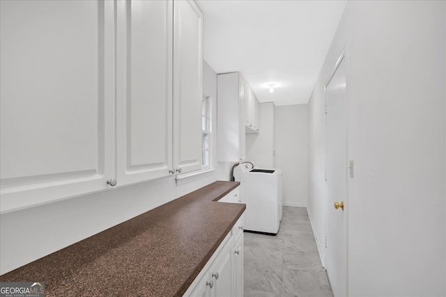 interior space with washer / dryer, laundry area, marble finish floor, and baseboards