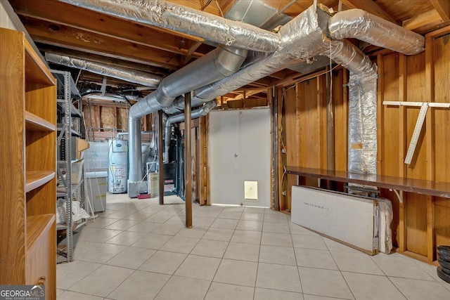 unfinished basement with tile patterned flooring and water heater