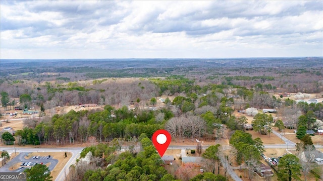 aerial view featuring a wooded view