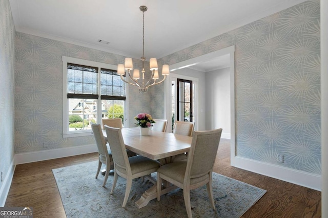 dining space featuring wallpapered walls, plenty of natural light, baseboards, and wood finished floors