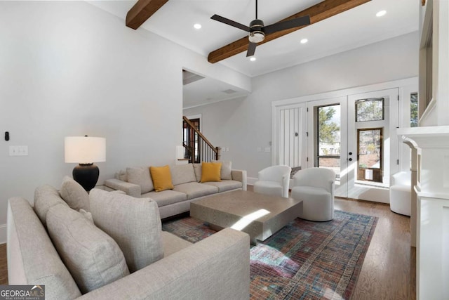 living area featuring stairway, wood finished floors, beam ceiling, and recessed lighting