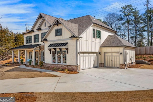 modern farmhouse style home featuring board and batten siding, brick siding, driveway, and roof with shingles