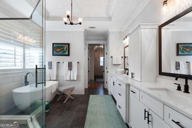 full bathroom with double vanity, a soaking tub, a sink, and a healthy amount of sunlight