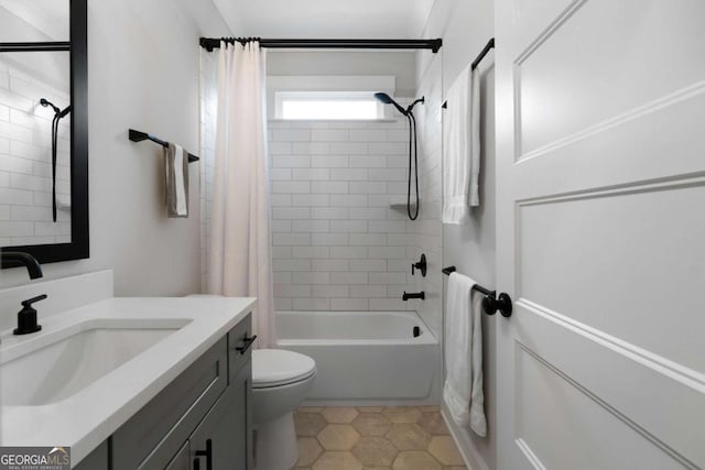 bathroom featuring vanity, tile patterned flooring, shower / bath combination with curtain, and toilet