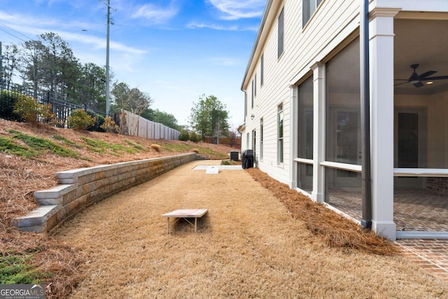 view of yard with a sunroom and fence