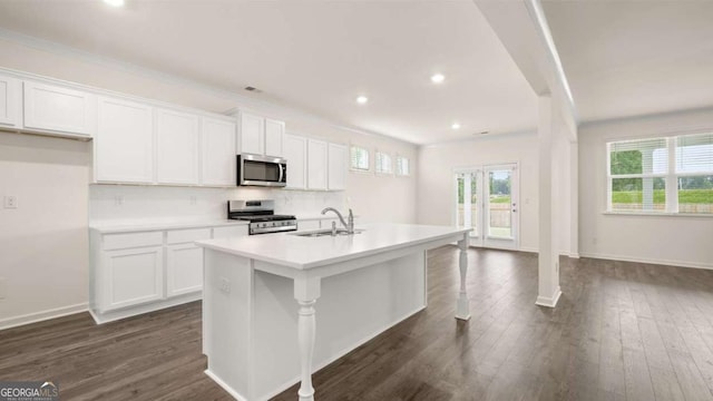1039 Blue Juniper Cir, Loganville, GA 30052 - kitchen featuring appliances with stainless steel finishes, a center island with sink, white cabinetry, dark wood-style flooring, and recessed lighting
