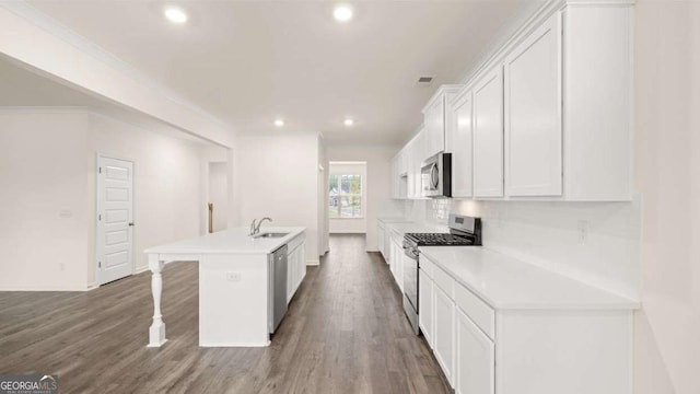 1039 Blue Juniper Cir, Loganville, GA 30052 - kitchen featuring stainless steel appliances, a center island with sink, recessed lighting, white cabinetry, and dark wood-style floors