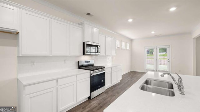 1039 Blue Juniper Cir, Loganville, GA 30052 - kitchen featuring appliances with stainless steel finishes, decorative backsplash, white cabinetry, light countertops, and recessed lighting