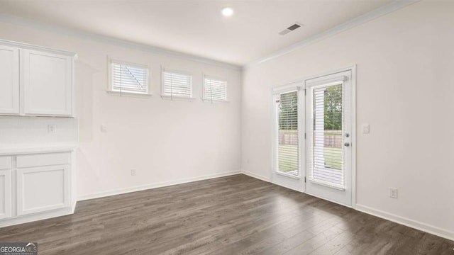 1039 Blue Juniper Cir, Loganville, GA 30052 - spare room featuring crown molding and dark wood finished floors