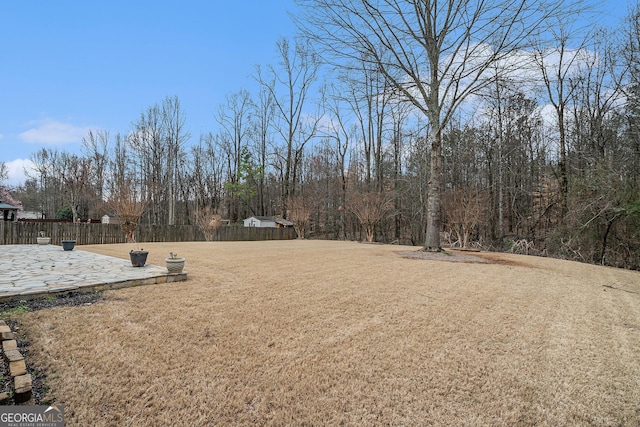 view of yard with fence and a patio