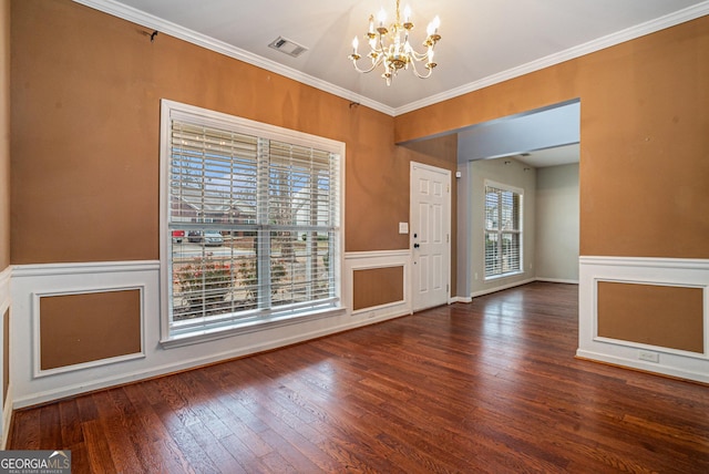 interior space with hardwood / wood-style flooring, wainscoting, visible vents, and a notable chandelier