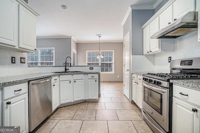 kitchen featuring white cabinets, appliances with stainless steel finishes, crown molding, under cabinet range hood, and a sink