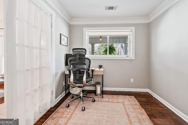 office space with visible vents, crown molding, baseboards, and wood finished floors