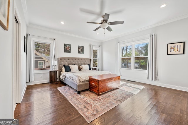 bedroom featuring dark wood-style floors, multiple windows, crown molding, and baseboards