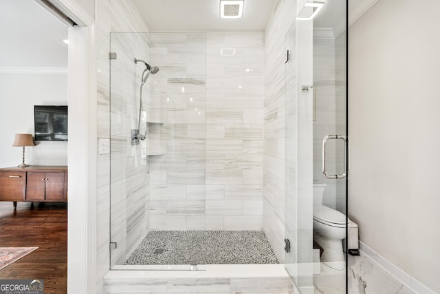 full bath with baseboards, a stall shower, and ornamental molding