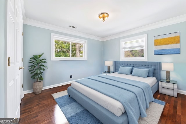 bedroom with visible vents, baseboards, wood finished floors, and ornamental molding