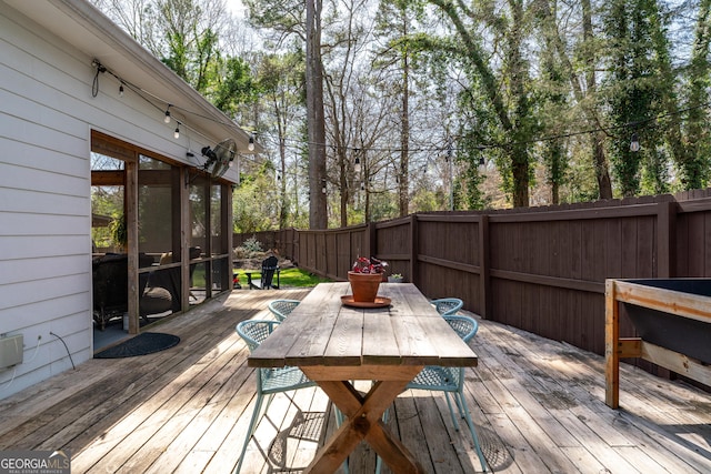 wooden terrace featuring outdoor dining space and fence