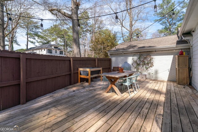 deck with outdoor dining space and fence