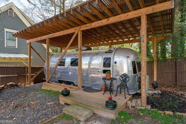 view of car parking with a detached carport and fence