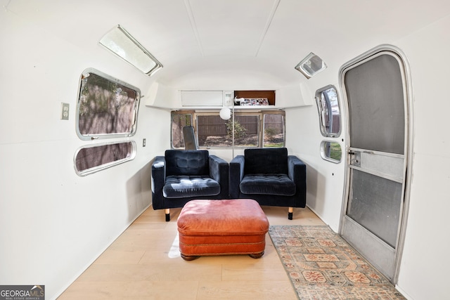 living area featuring lofted ceiling and wood finished floors