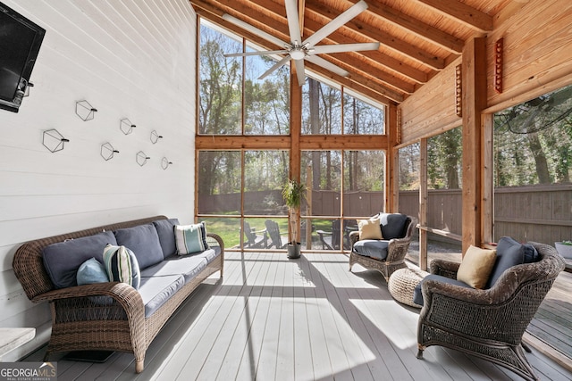 sunroom / solarium with wooden ceiling, vaulted ceiling with beams, and a ceiling fan