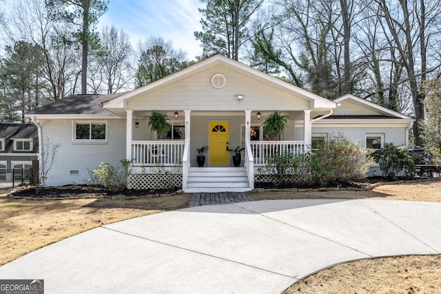 ranch-style house featuring crawl space, brick siding, and a porch