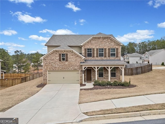 view of front of house featuring brick siding, a garage, fence, and driveway