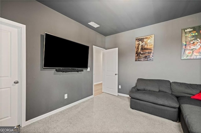 carpeted living area featuring baseboards