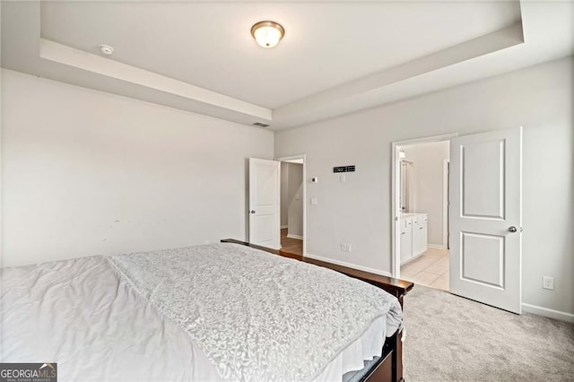 bedroom featuring visible vents, a raised ceiling, baseboards, and light colored carpet