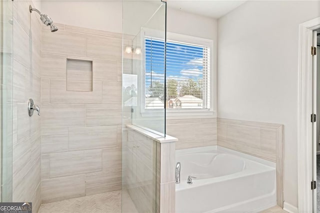 bathroom featuring a garden tub and a stall shower