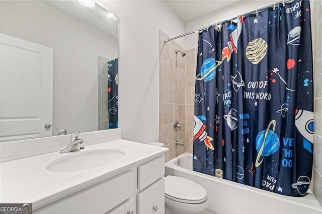 bathroom with shower / bath combo with shower curtain, toilet, and vanity
