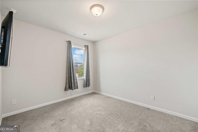 spare room with carpet floors and baseboards